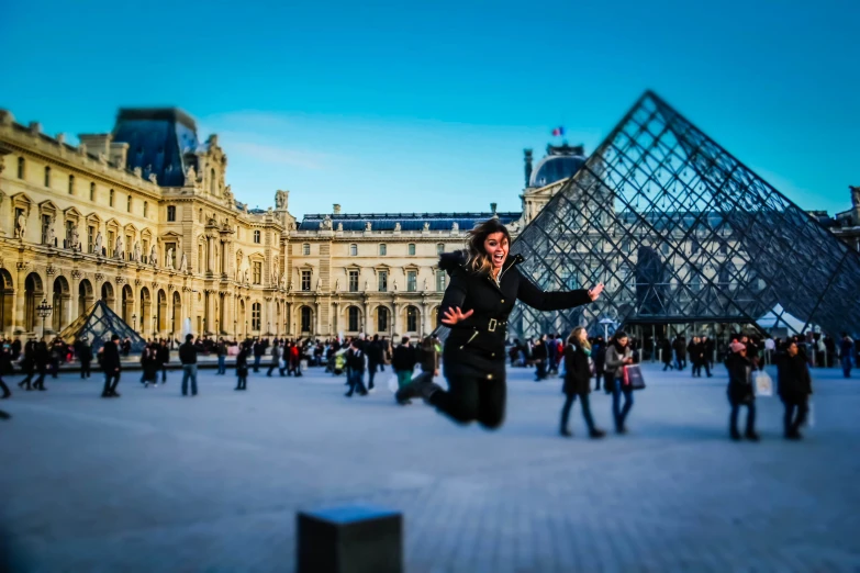 a woman in black jacket standing in front of the pyramid