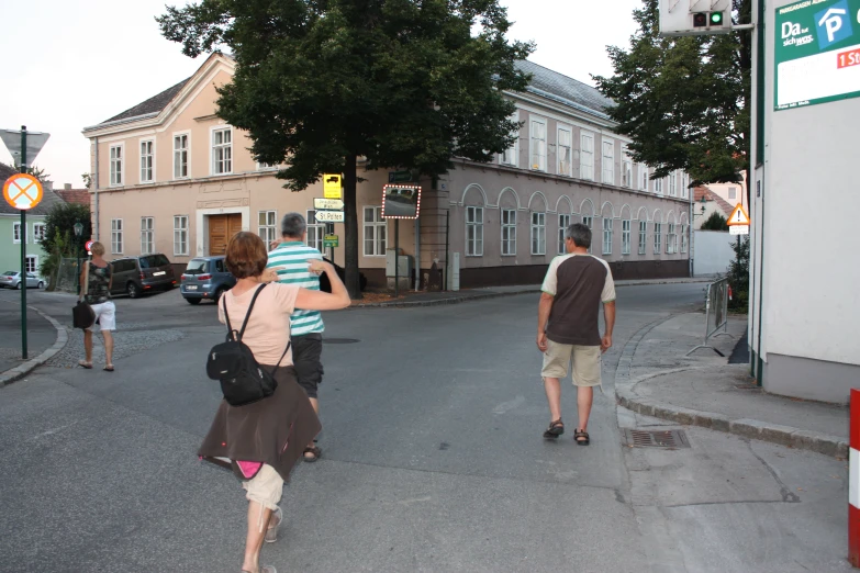 a couple walks together on a street in a small town