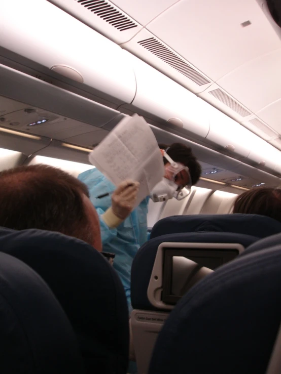 some people sitting in chairs on an airplane