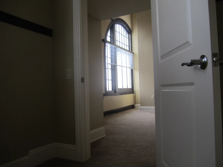 a hallway with open doors and windows