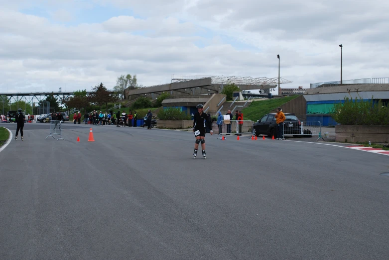 skateboarders ride their bikes on a paved road