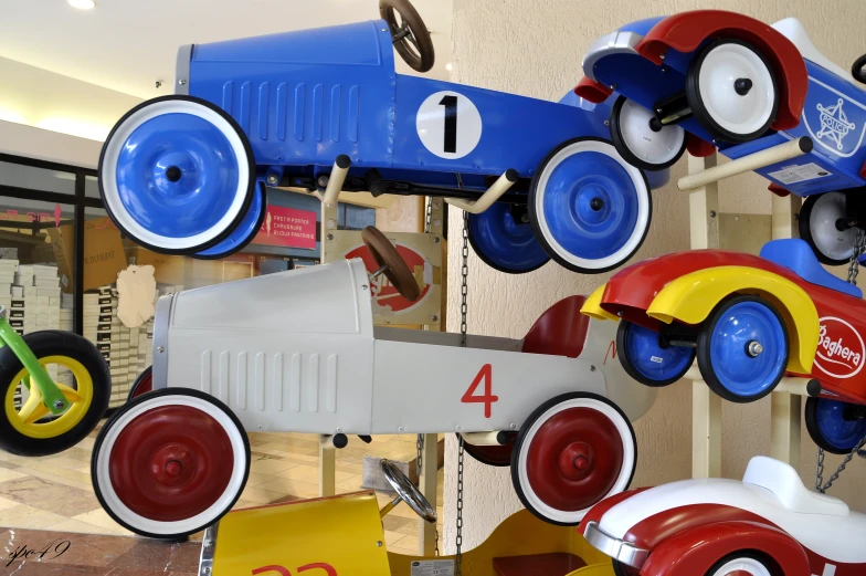 colorful toy vehicles hanging on the wall in a store