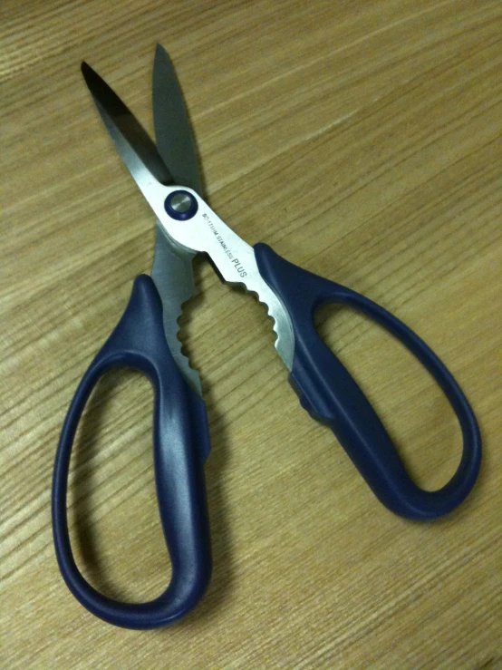 black and blue handled scissors on table with white top