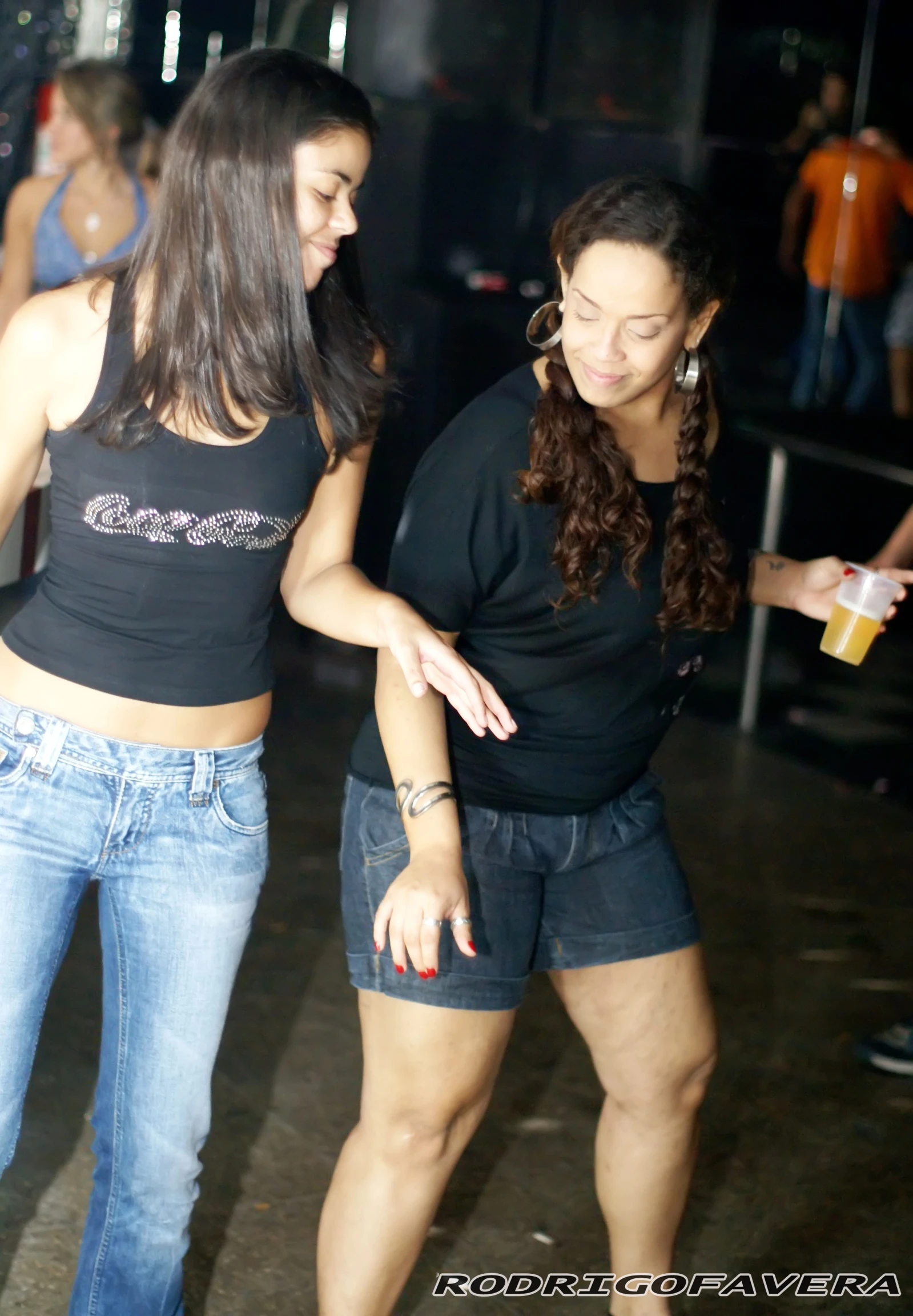 two pretty young ladies dressed in jean shorts