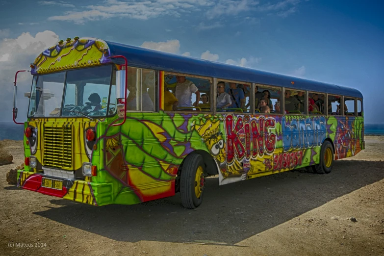 a colorful bus is sitting in front of a group of people