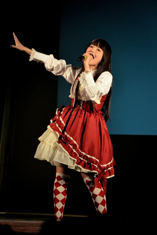 a female in a red skirt on a stage