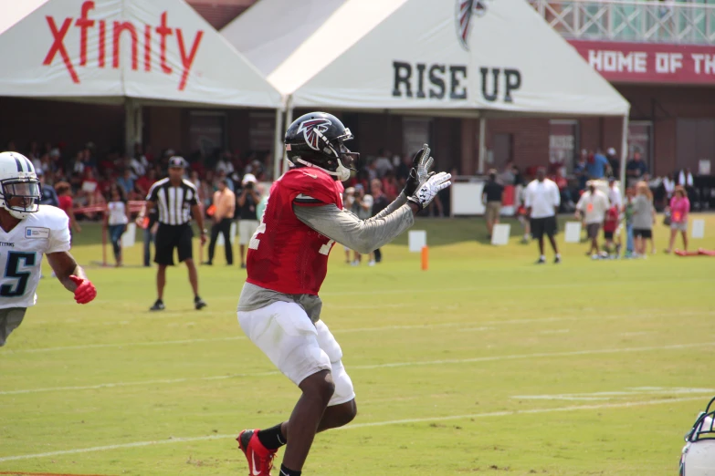 a football player holding his arm open and ready to catch the ball