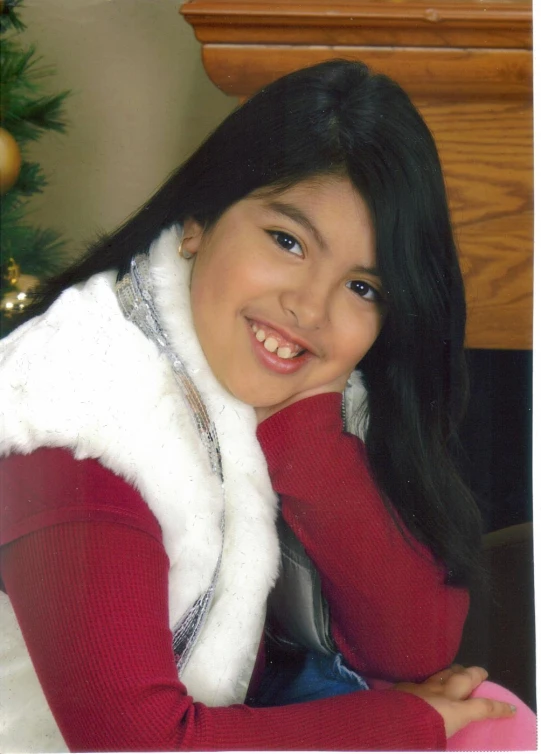 an image of a smiling girl with long black hair