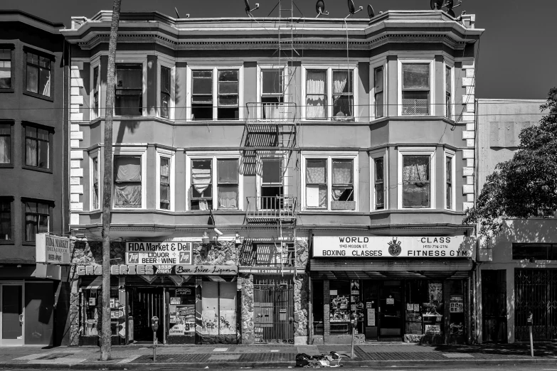 the facade of a three story building in a neighborhood