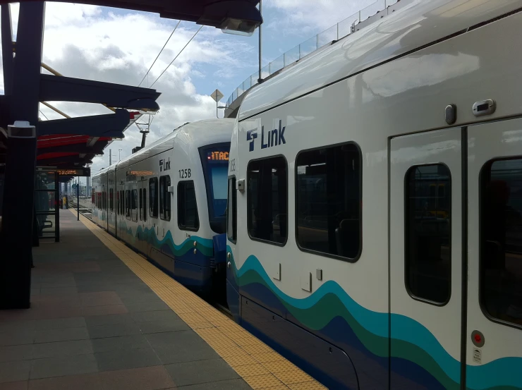 a train parked next to a platform on the ground