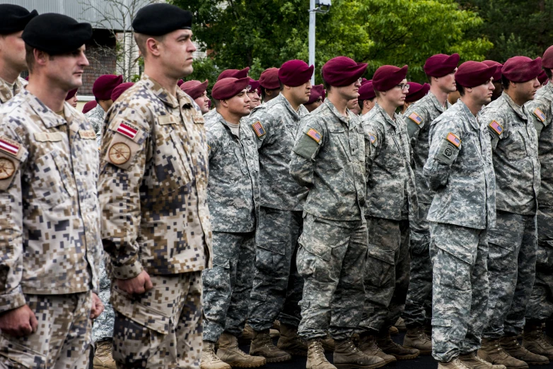 several soldiers in camouflage uniforms standing together