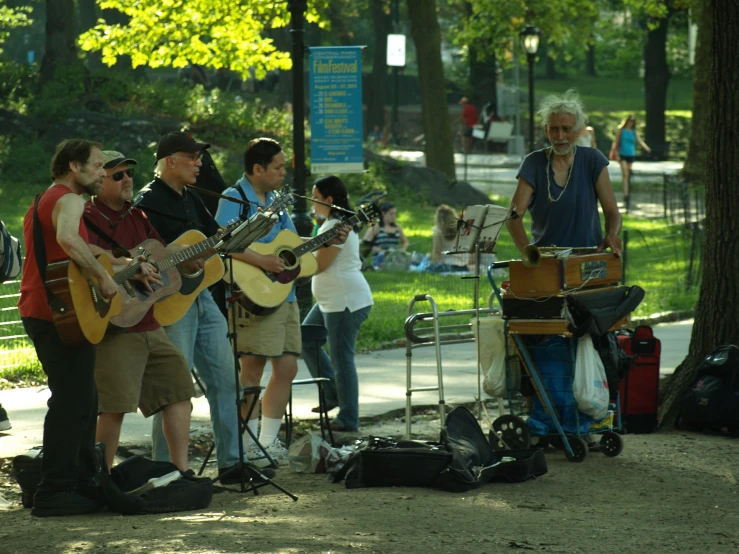 a group of people playing music in the park