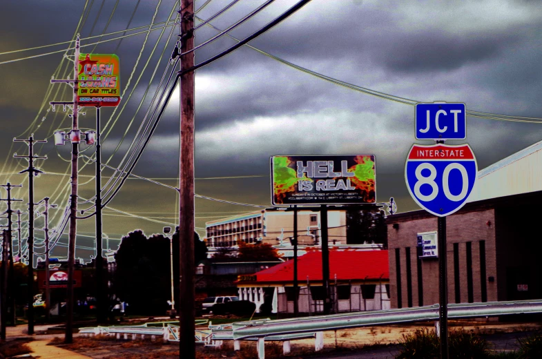 an empty street with signs and buildings in the background