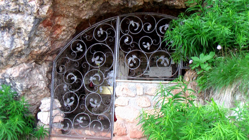 the gate of an old house is made of iron