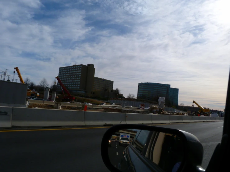 a road with several cranes on the other side