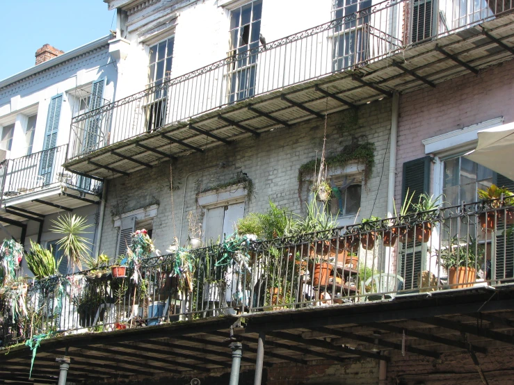 an old building with lots of hanging plant pots