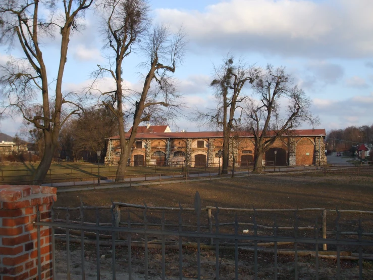 a brick building with trees around it