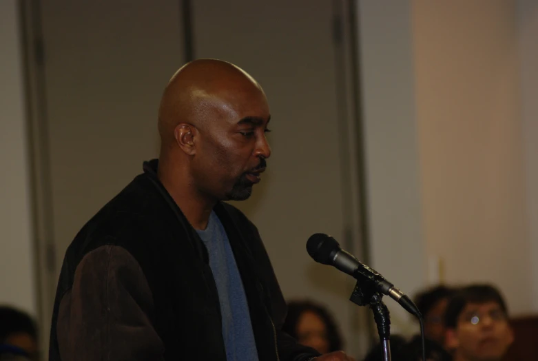 a man at a podium with people behind him