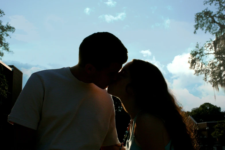 a man kisses the nose of a woman