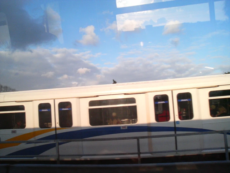 a passenger train is passing a parking lot