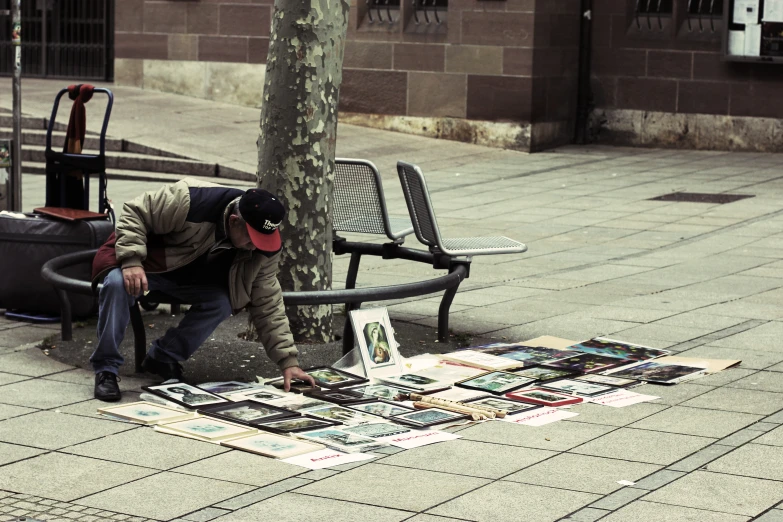 a man putting posters on a street