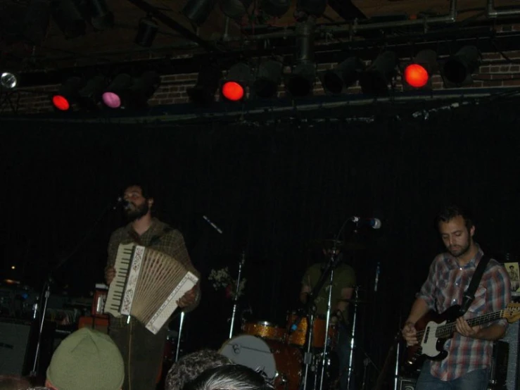 a band playing on stage in front of spectators