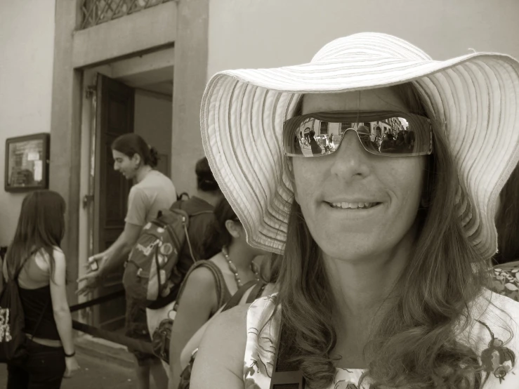 a woman wearing a large hat and sun glasses