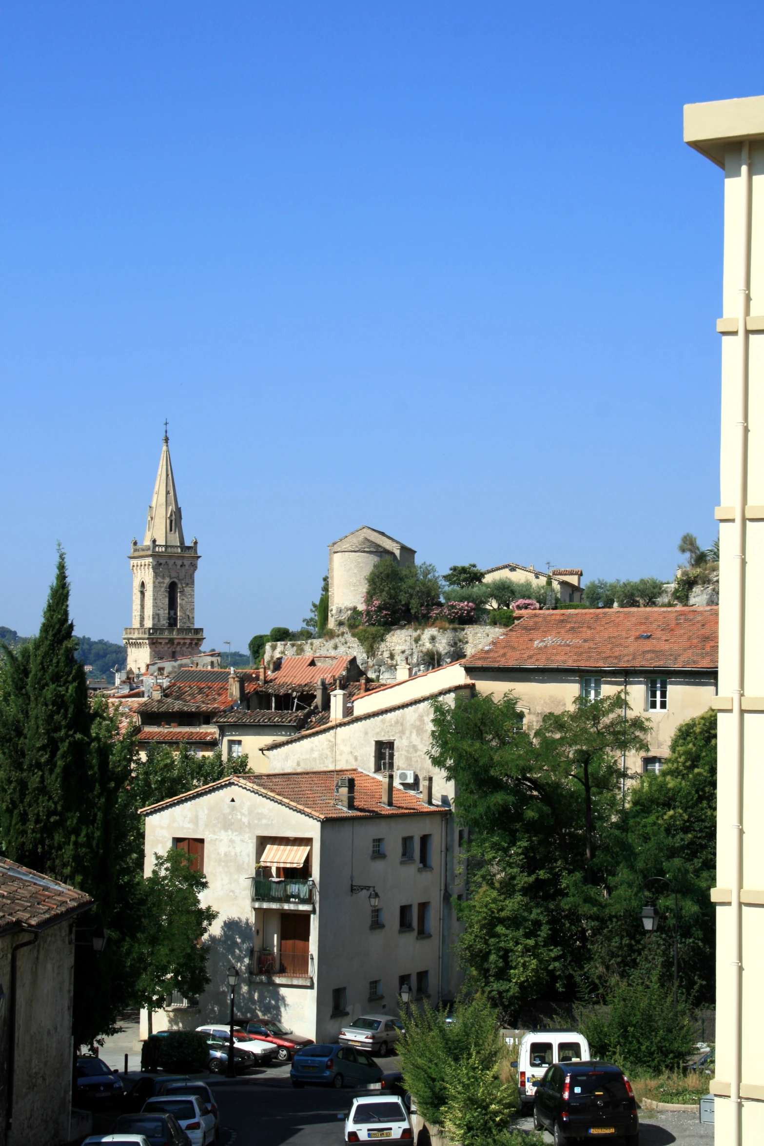 an aerial s of several buildings with a church steeple in the distance