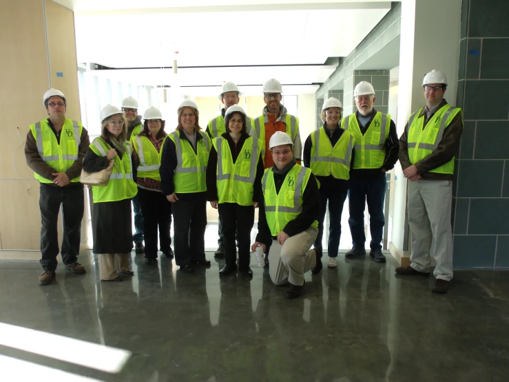 a group of people in safety vests pose for a picture