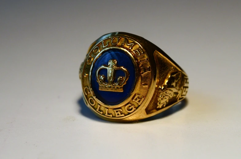 a ring with the emblem on it sitting on a table