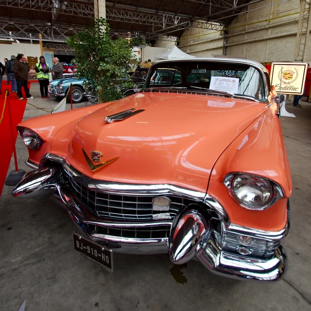 an orange car parked inside of a building