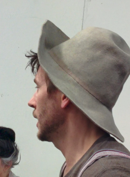 man wearing grey hat with side profile cut out