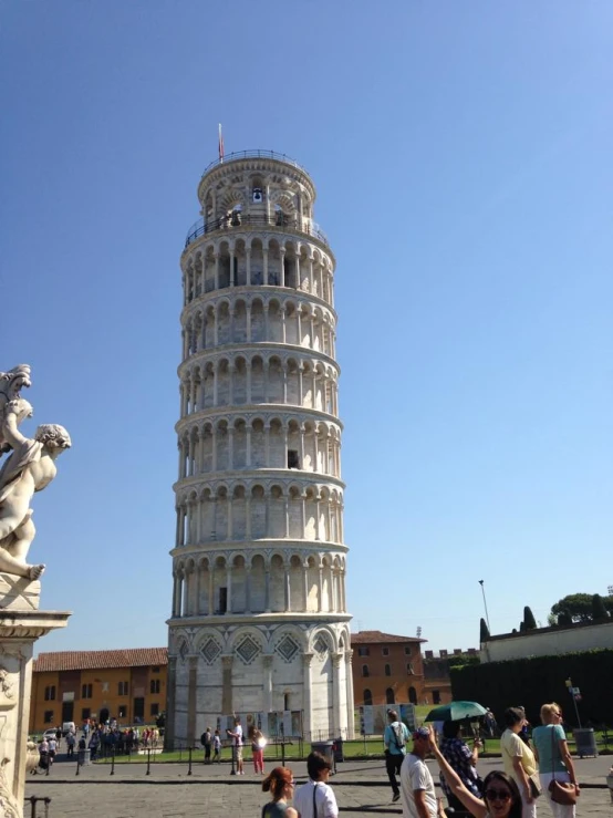 tourists stand outside the leaning tower of pisa