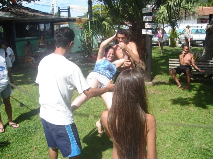 a group of people are huddled in the yard