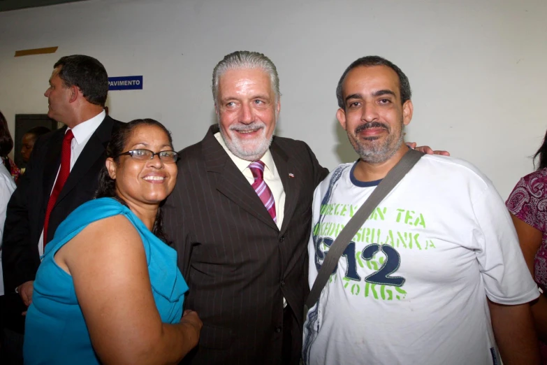 a group of three people are posing for a picture