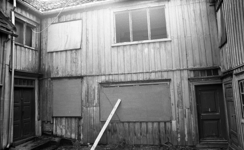 the outside of an old building with wooden siding