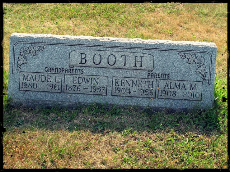 a headstone for both of two people who were buried in the woods