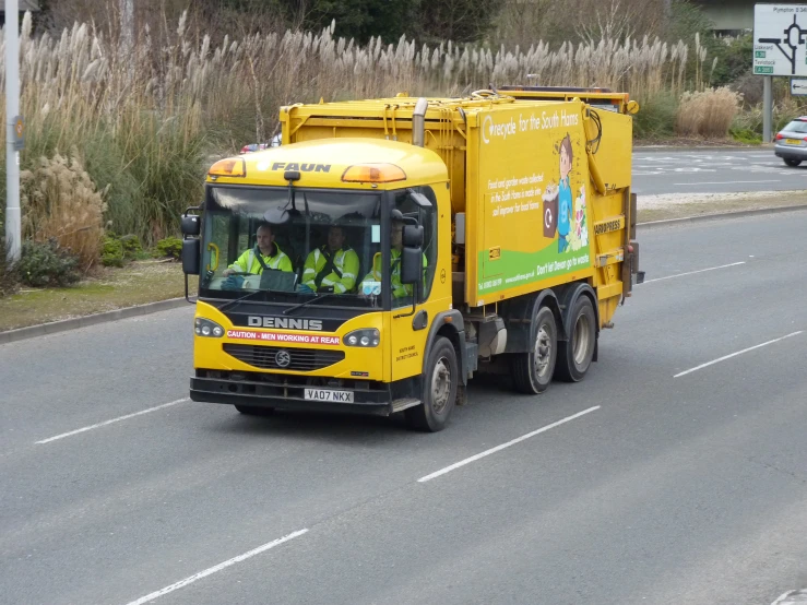 there is a yellow truck on the street