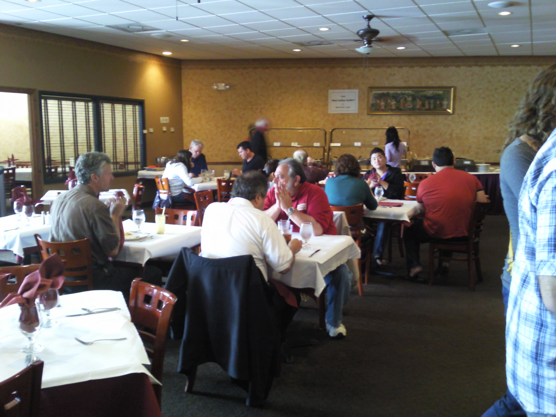 a group of people eating at a restaurant