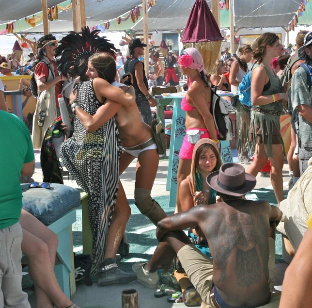 a group of people are gathered on the beach