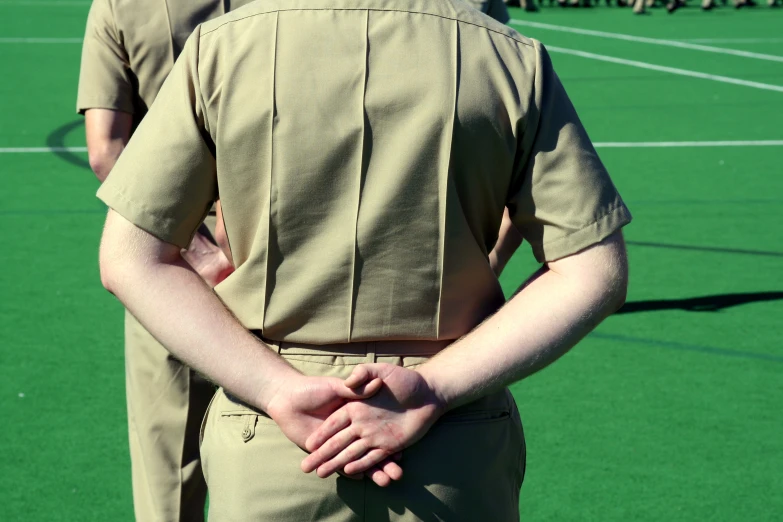 a man in uniform putting his hands on his chest