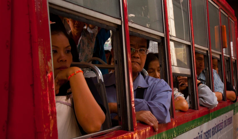 several people sitting in a window in a train