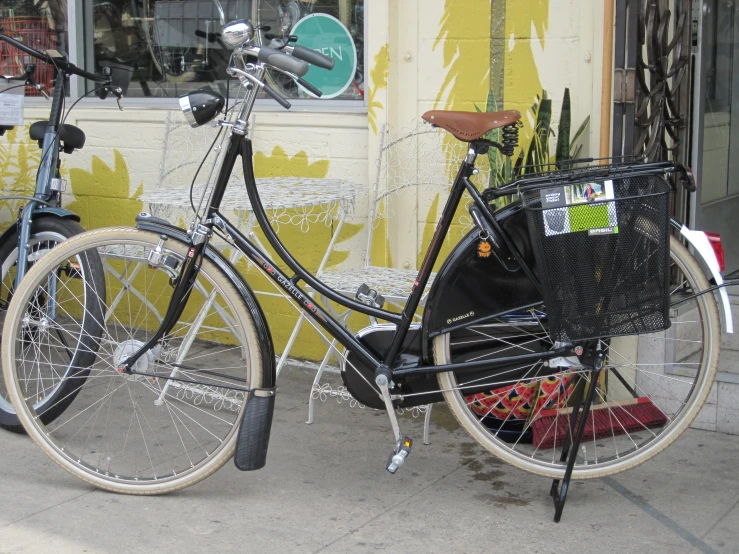 a bicycle parked by the window of a shop