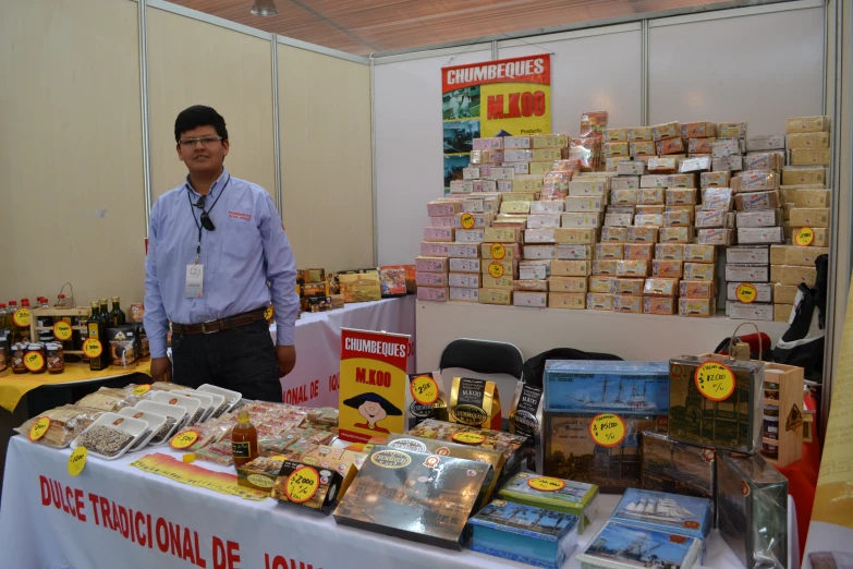 a person standing next to a table covered in fake items