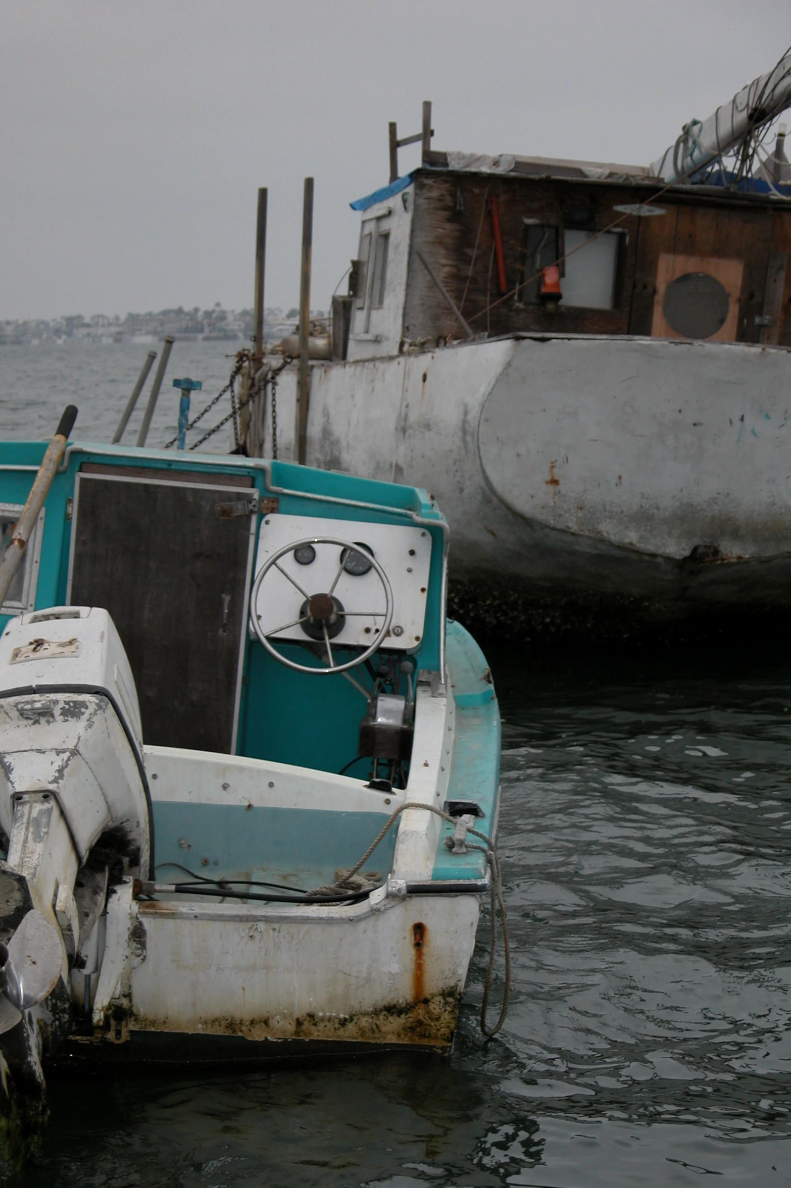 two boats on a bay sitting next to each other