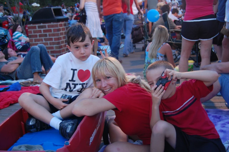 a couple of girls and a boy are posing for the camera