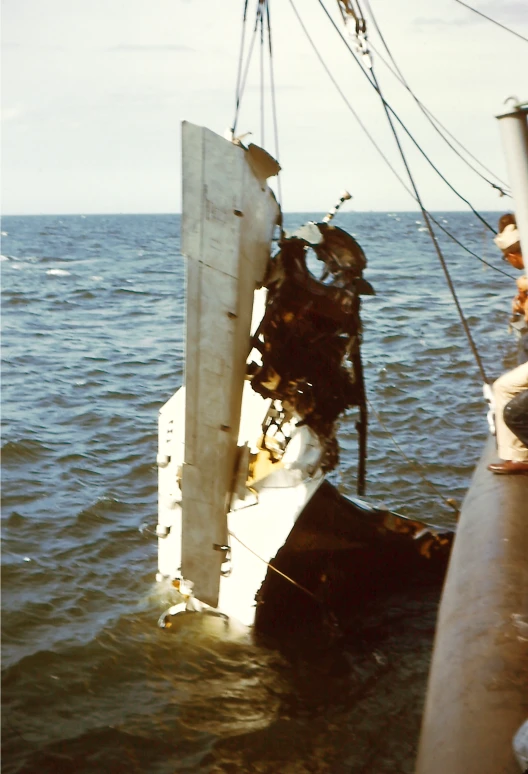 a boat that is in the ocean and its contents were still sticking out of the water