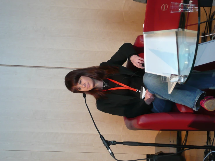 a person sitting in front of a microphone with a laptop