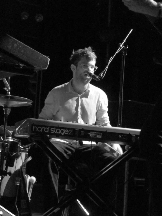 a man that is playing a keyboard on a stage
