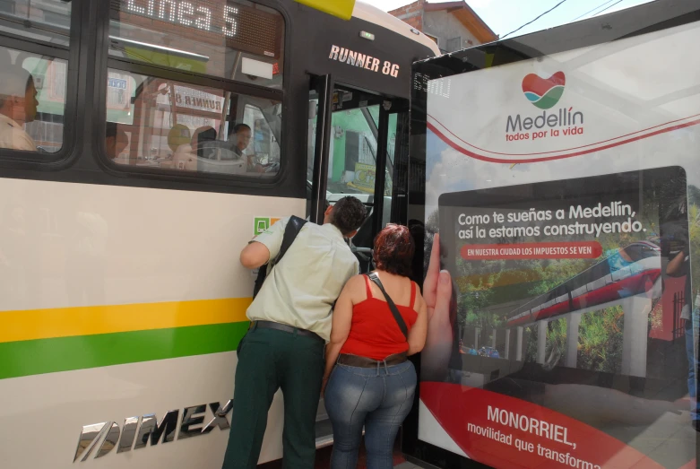 two people putting onto a bus with a map attached